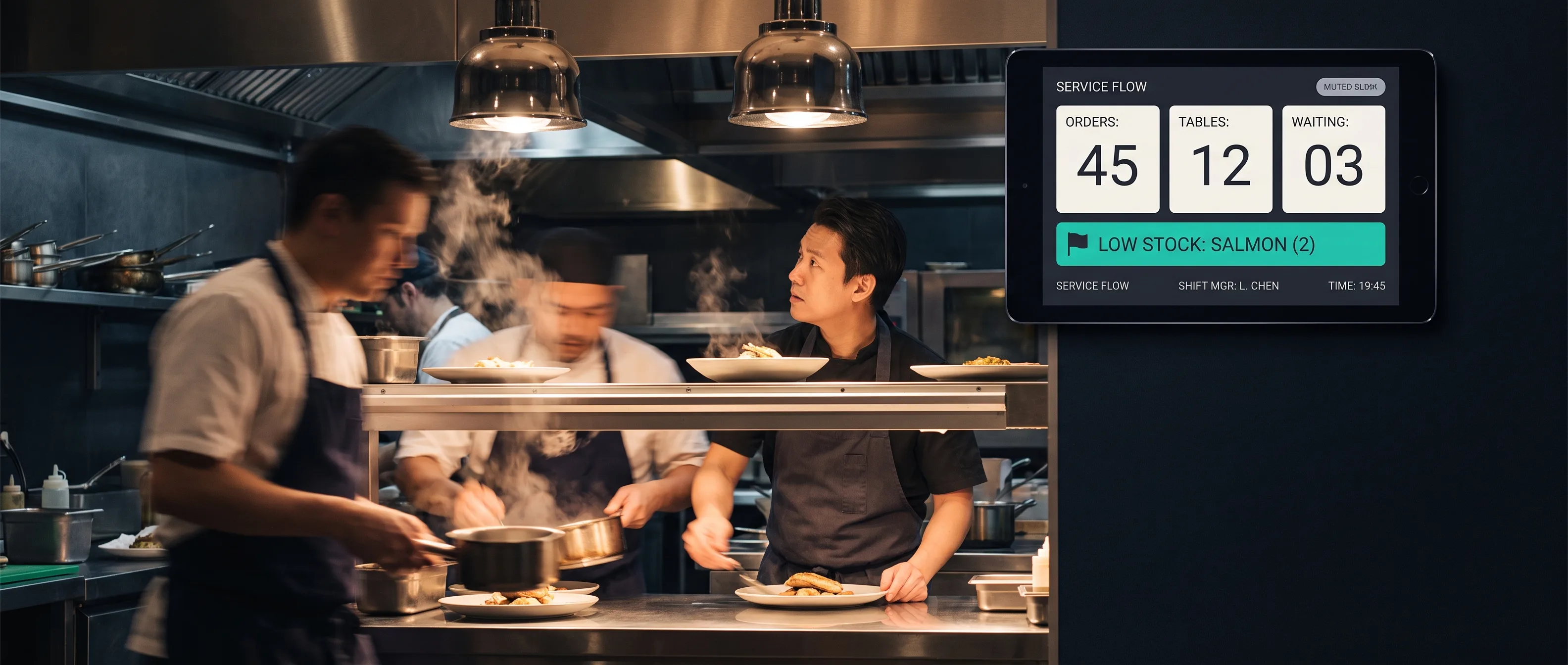 A shift manager mid-service glances up at a wall tablet showing a glanceable board of prep counts and low-stock flags in a busy kitchen.